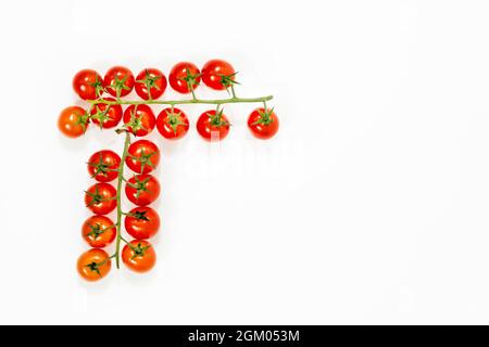 Two branches of ripe cherry tomatoes viewed from the top and placed on a white surface Stock Photo