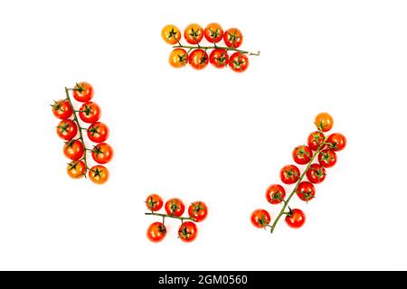 Clusters of ripe red cherry tomatoes viewed from the top on white background Stock Photo