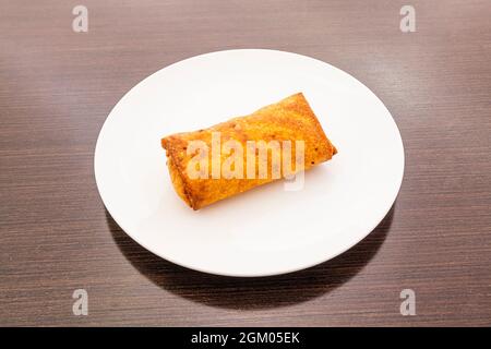 Crispy Chinese spring roll stuffed with vegetables and meat popular in Chinese restaurants Stock Photo