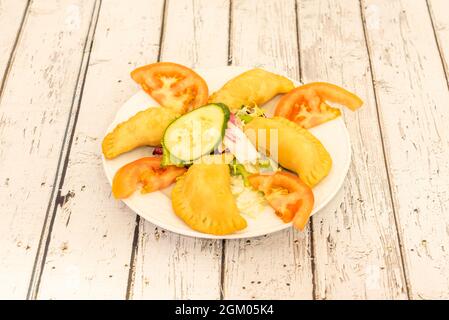 Appetizer serving of samosas served in a kebab restaurant Stock Photo