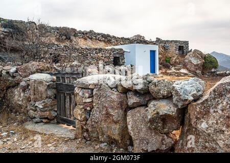 Farm shelter for tools and animals inside a rocky coral showing both old and new structure Stock Photo