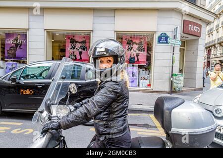 Paris France,9th arrondissement,Rue de la Victoire,French woman female motorcycle rider helmet wearing black leather jacket Stock Photo