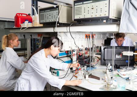 Students performing experiments in laboratory Stock Photo