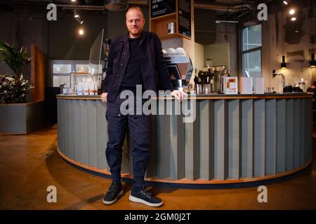 Berlin, Germany. 30th Aug, 2021. Entrepreneur Ansgar Oberholz is standing in his café on Torstraße. He has new plans - for the countryside. His company is planning projects for living, working and living combined in rural areas. (to dpa ''St. Oberholz' boss plans projects in the countryside') Credit: Paul Zinken/dpa/Alamy Live News Stock Photo