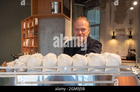 Berlin, Germany. 30th Aug, 2021. Entrepreneur Ansgar Oberholz is standing in his café on Torstraße. He has new plans - for the countryside. His company is planning projects for living, working and living combined in rural areas. (to dpa ''St. Oberholz' boss plans projects in the countryside') Credit: Paul Zinken/dpa/Alamy Live News Stock Photo