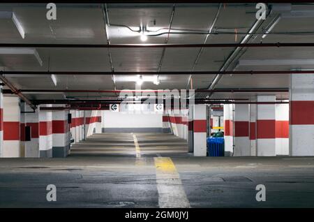 Well lit empty underground parking garage Stock Photo