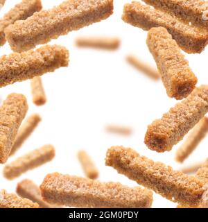 Bread croutons levitate on a white background Stock Photo