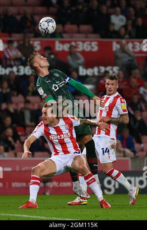 Barnsley's Cauley Woodrow misjudges an attempt to win an aerial battle.Picture: Liam Ford/AHPIX LTD, Football, EFL Championship, Stoke City v Barnsley Stock Photo