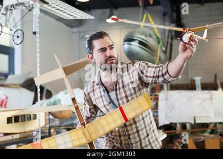 Happy male with monoplane models Stock Photo