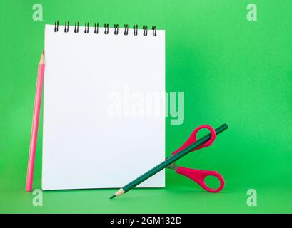 School supplies on bright green background with copyspace. Back to school concept. Stock Photo