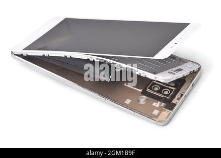 Broken smartphone with  swollen battery isolated on white Stock Photo