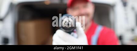 Smiling male master builder holding drill closeup Stock Photo