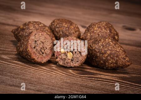 Traditional kebbe and pita bread on big round plate in lebanese restaurant Stock Photo