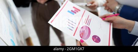 In hands of business employees are charts with commercial and financial indicators Stock Photo