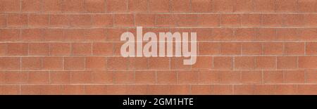 Panoramic wall made of red square concrete stones Stock Photo