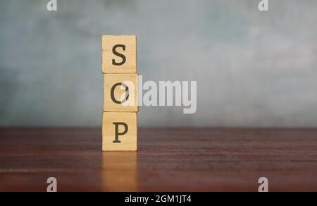 Stack wooden cube with text SOP or standard operating procedure. Copy space for text Stock Photo