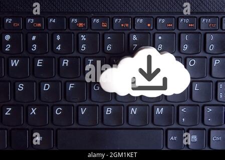 Technology, cloud computing concept. White cloud with download icon on keyboard Stock Photo