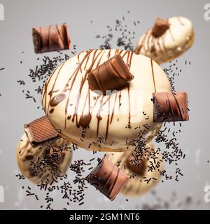 Flying donuts concept. Donuts with white chocolate glaze and chocolate Stock Photo