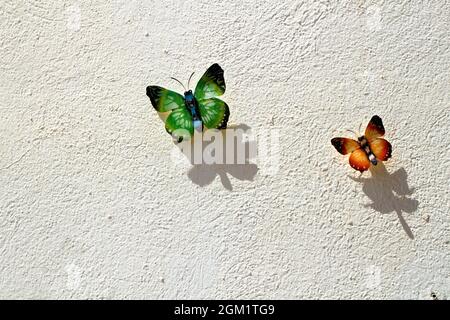 Two decorative butterflies on white wall of a house in Spain Stock Photo