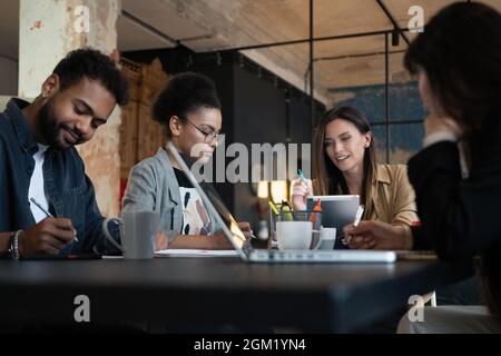 Group of young multiracial people working in modern office. Businessmen at work during meeting. Stock Photo