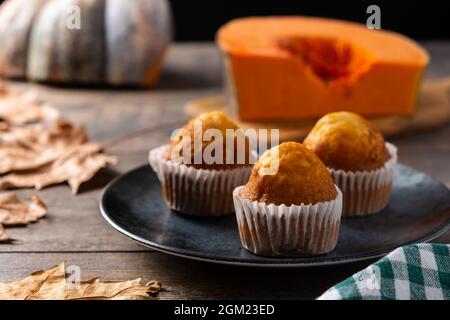 Pumpkin muffins on wooden table Stock Photo
