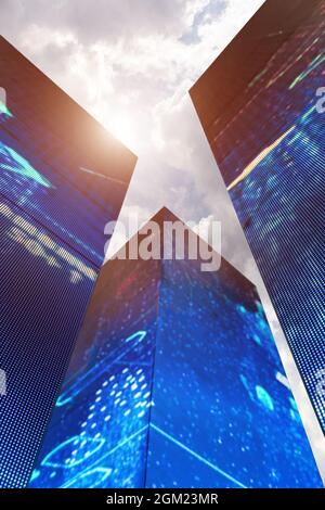 low angle view of futuristic business data made skyscrapers and cloudy sky. Stock Photo