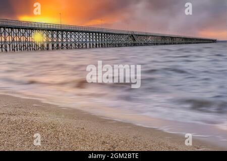 Sundown At Keansburg Pier - View to the 2000 foot pier overlooking the Raritan Bay, in the borough of Keansburg in Monmouth County, New Jersey.   Tour Stock Photo