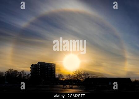 Jersey Shore Sun Halo - A rare halo forms around the sun.   A Sun halo is caused by the refraction, reflection, and dispersion of light through ice pa Stock Photo