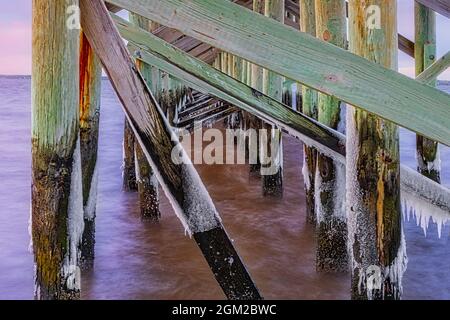 Keansburg NJ Pier - Winter view of the frozen pier covered in icicles.  The 2000 foot fishing pier overlooks the Raritan Bay, in the borough of Keansb Stock Photo