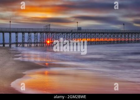 Sunset At Keansburg Pier - View to the 2000 foot pier overlooking the Raritan Bay, in the borough of Keansburg in Monmouth County, New Jersey.   Touri Stock Photo