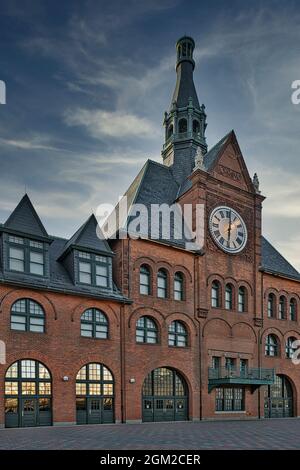 CRRofNJ Terminal - View to the red brick facade, steeple and outdoor clock. The terminal is also known as the Communipaw Terminal in Liberty State Par Stock Photo