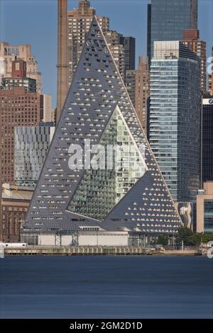 NYC Empire Pyramid - The midtown Manhattan New York City skyline is bathed with warm light from the setting sun and cool hues during the blue hour at Stock Photo