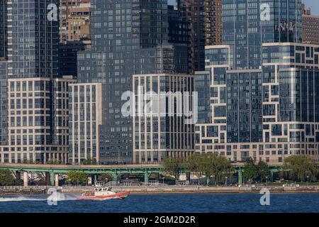 US Coast Guard NYC - A United States Coast Guard boat sails by the New York City skyline in upper Manhattan.   Seen in the background are some of the Stock Photo