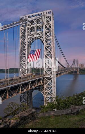 George Washington Bridge USA GWB  - View of the New Jersey NJ side stanchion with the worlds largest free flying American flag.   The GW is also refer Stock Photo