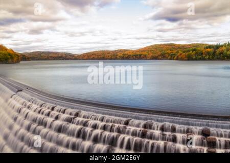 New Croton Dam Reservoir - Croton Dam waterfall also known as the Cornell Dam during a beautiful autumn afternoon. The golden warm hues of fall adorn Stock Photo