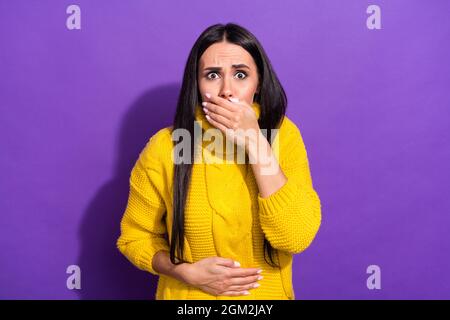 Portrait of displeased girl arm on stomach covering mouth feel bad isolated on purple color background Stock Photo