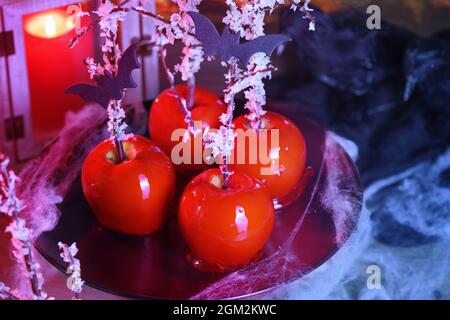 Halloween dessert. Poisoned blood caramelized glazed candy apple. Snow White Poison Lollipops. Stock Photo