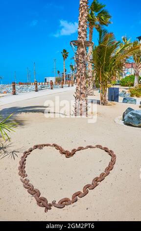 The heart of chain on the sand installation at the walkway of La Mer beach, Dubai, UAE Stock Photo