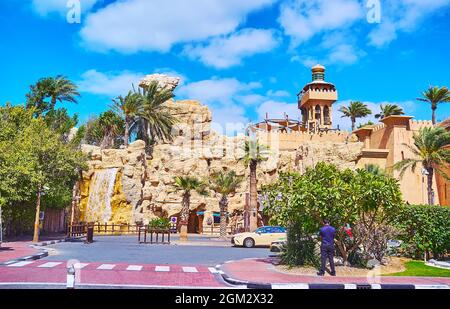 The stone wall of Wild Wadi Waterpark with a waterfall and scenic garden, Jumeirah, Dubai, UAE Stock Photo