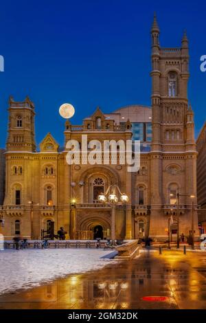 Moonrises In Philly - View to Center City  illuminated  during the blue hour with the moon rising behind the Masonic Temple.   This image is also avai Stock Photo