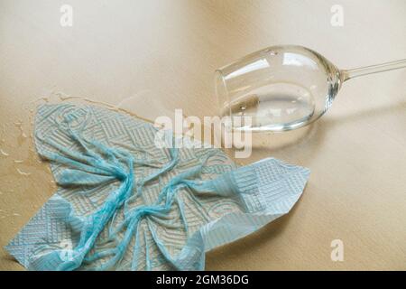 Mopping up a glass of spilled wine or water Stock Photo