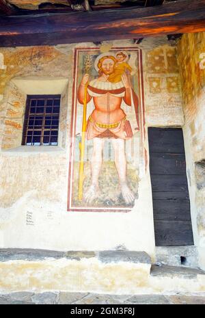 San Cristoforo (Christopher), among the oldest frescoes in  San Bernardo Romanesque Church, Monte Carasso, Canton of Ticino, Switzerland. Stock Photo