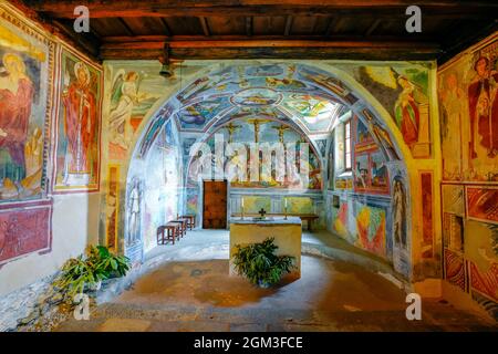 Frescoes in the apse of San Bernardo romanesque church in village of Curzutt. The church is only accessible on foot from Sementina and Monte Carasso o Stock Photo