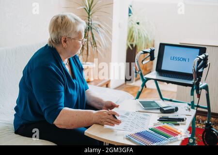 Hobby Ideas for Older People. Retirement Hobbies, Pastimes for Seniors. Activities for Seniors with Limited Mobility. Mature, elderly woman practices Stock Photo