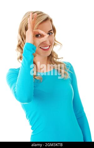 Portrait of a Caucasian woman showing ok sign on eye Stock Photo