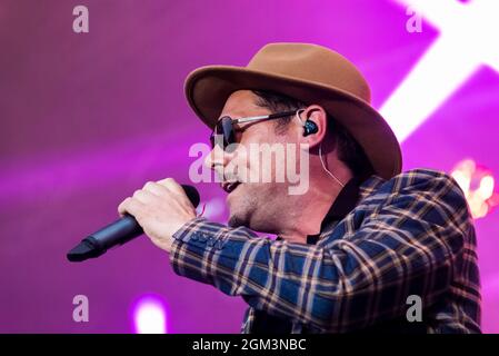 Tyber Cranstoun of The Dualers band performing at a music concert festival in Garon Park, Southend on Sea, Essex, UK. KZ ZST X in-Ear Earphone Stock Photo