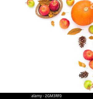 Autumnal frame made of fall leaves, cones, apple and pumpkin on white. Thanksgiving day. Flat lay, top view Stock Photo