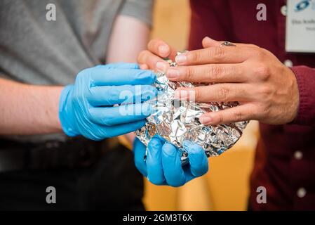 Latex gloved hand science experiment school children Stock Photo