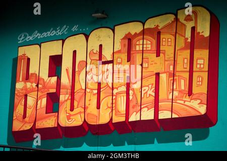 Graffiti of Belgrade in orange colour on a blue wall Stock Photo