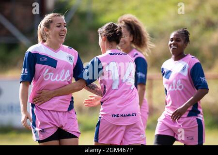 Sophie Manzi (L) and Lucy Monkman (14) smiling after scoring in the London and South East Regional Women’s Premier League, 21/22 season, wearing Dulwi Stock Photo